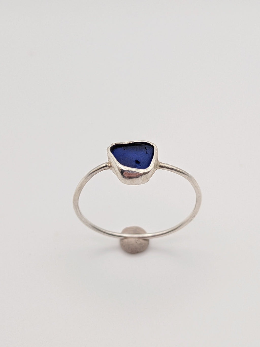 Blue sea glass ring in a handmade sterling silver setting with a fine silver bezel by All Our Light.