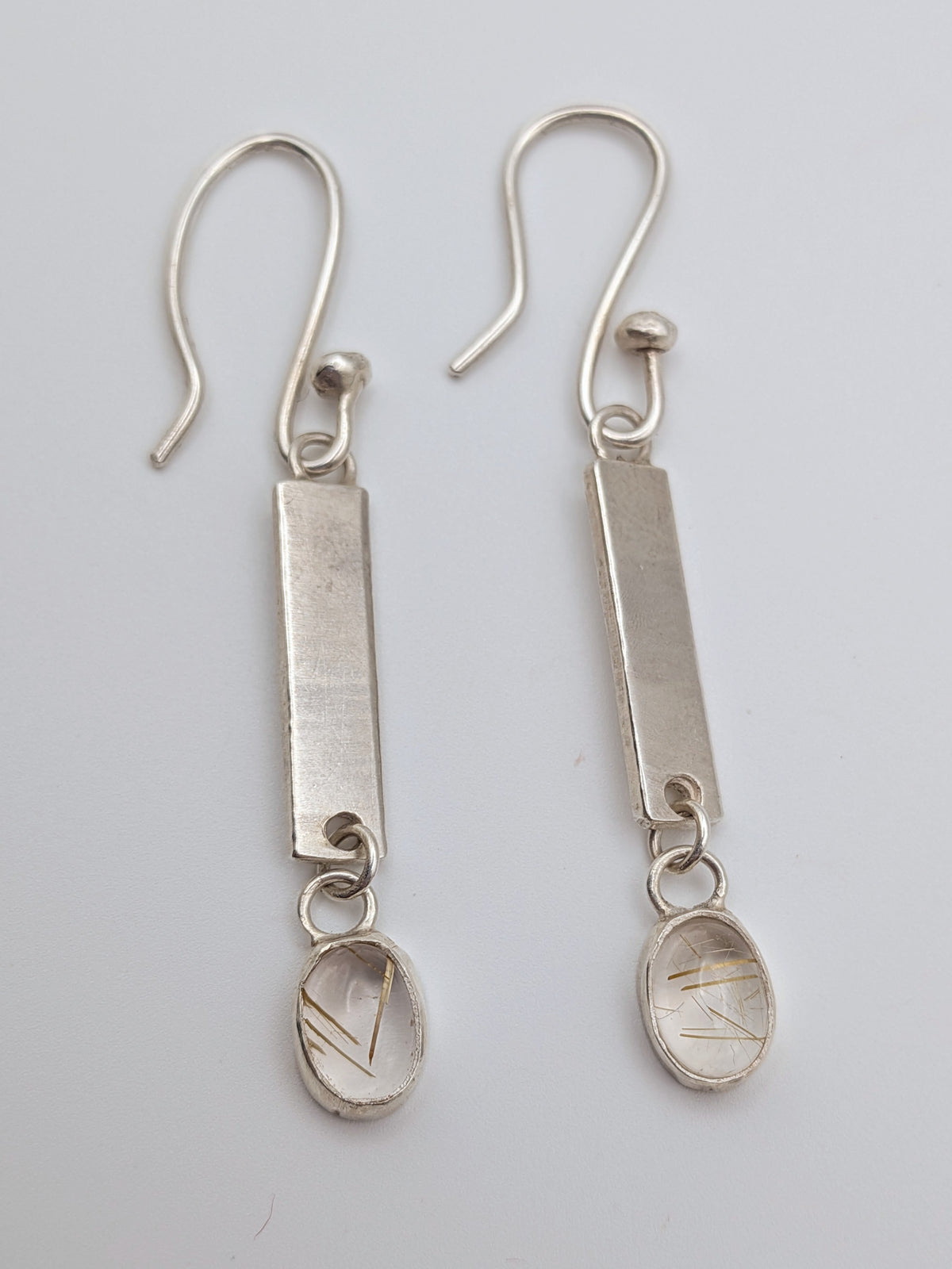 Handmade sterling silver drop earrings featuring rutilated quartz by All Our Light.