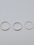 Handmade sterling silver stacking rings in round wire and D-profile designs by All Our Light.