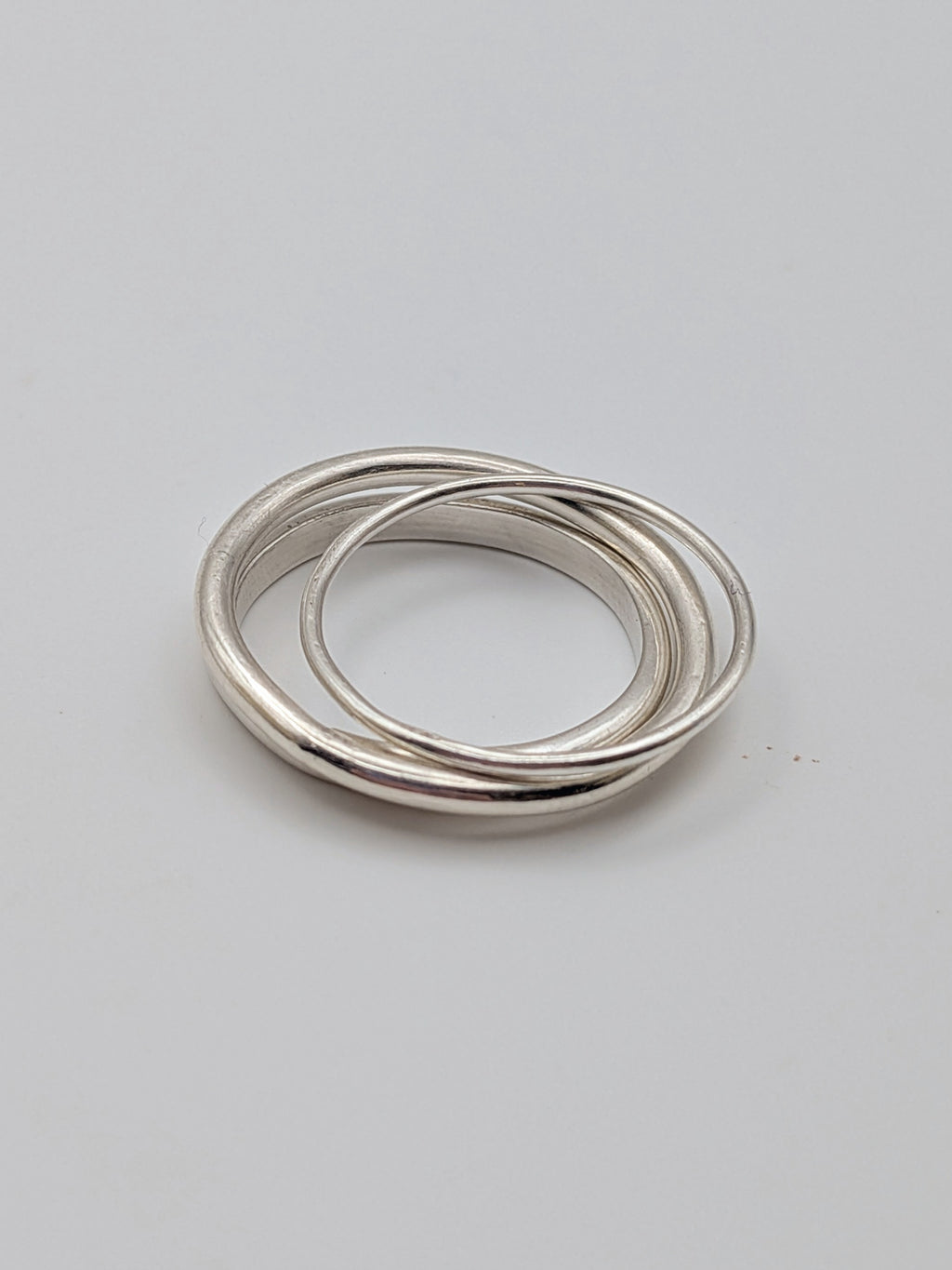 Handmade sterling silver stacking rings in round wire and D-profile designs by All Our Light.