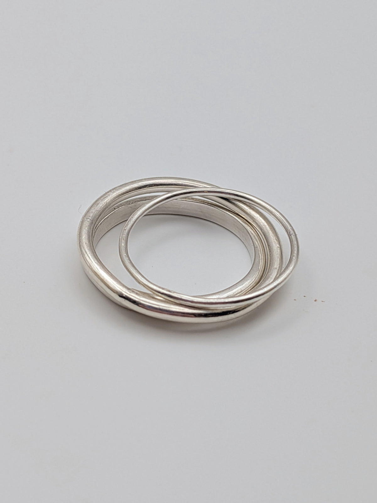 Handmade sterling silver stacking rings in round wire and D-profile designs by All Our Light.