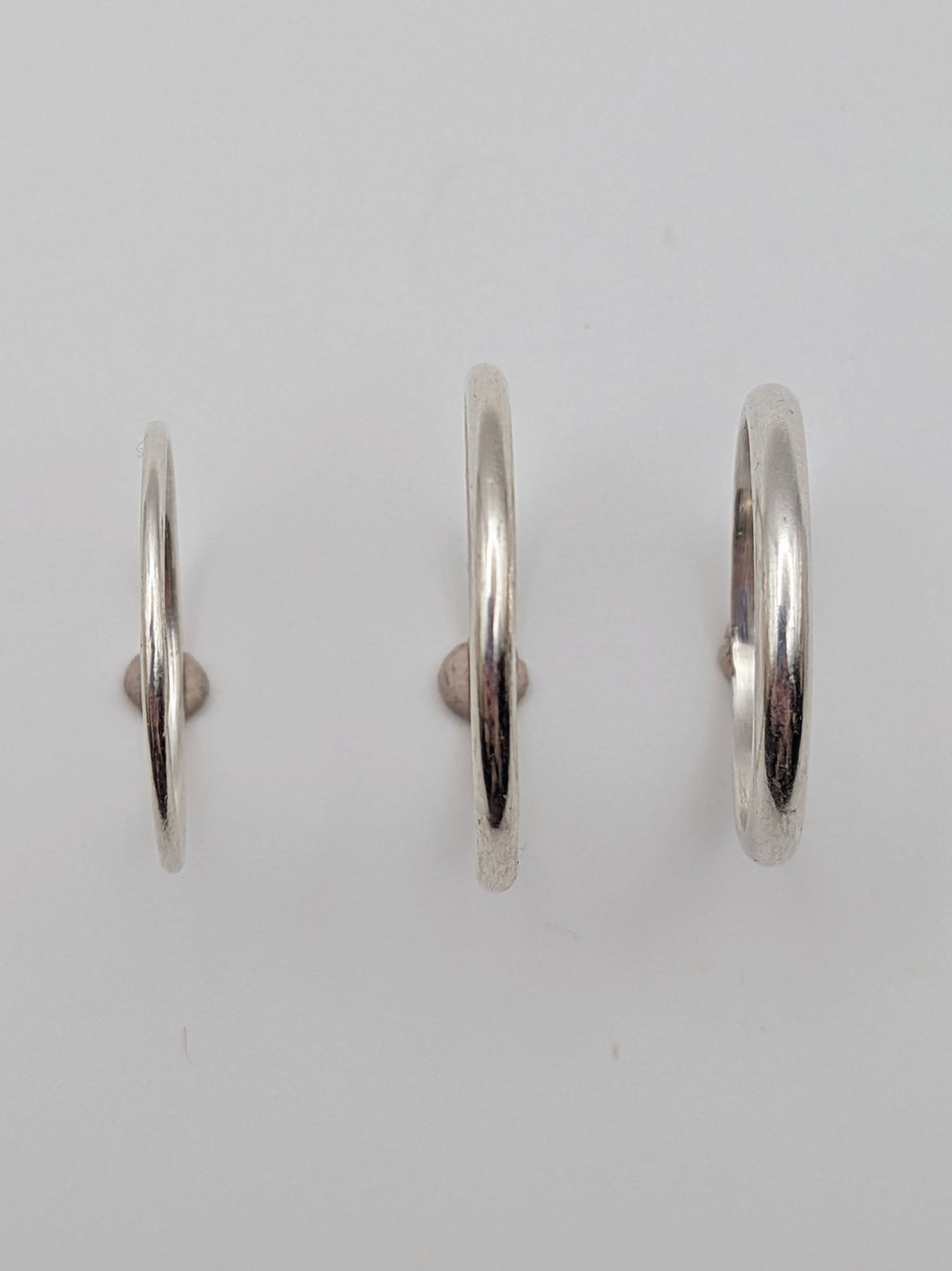Handmade sterling silver stacking rings in round wire and D-profile designs by All Our Light.