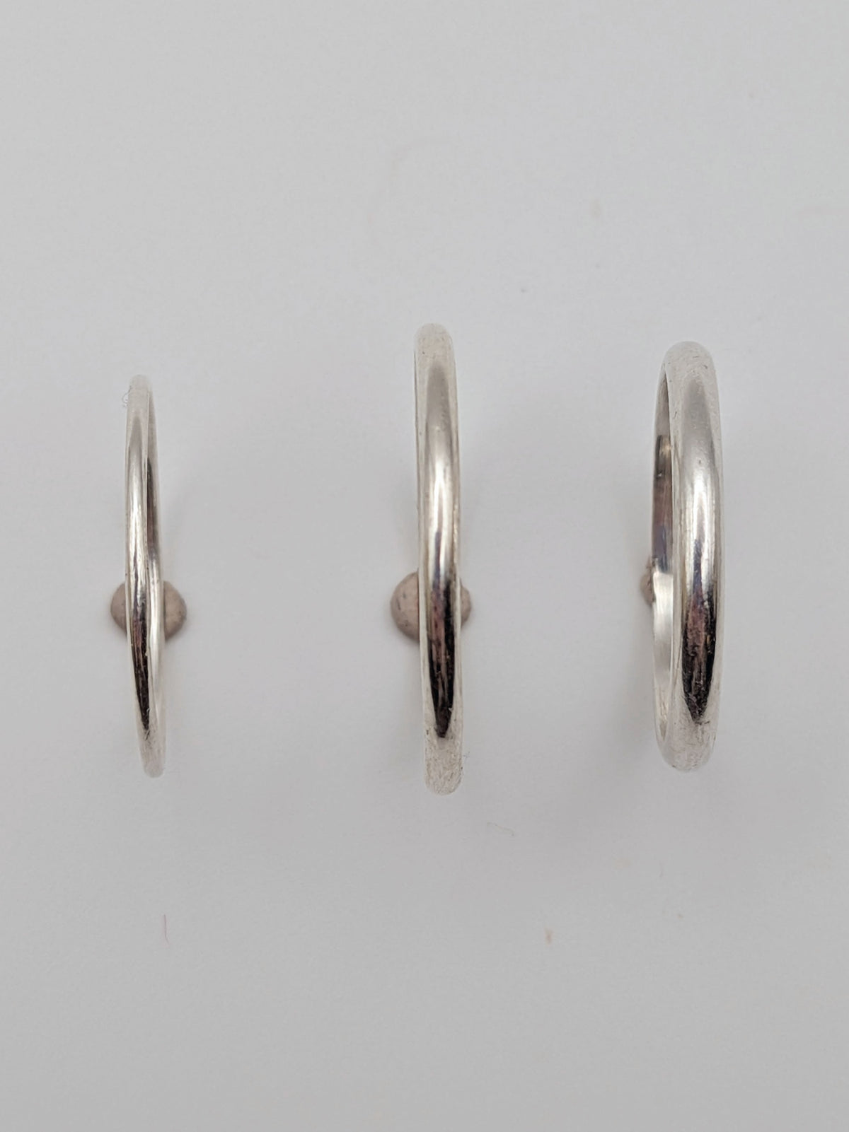 Handmade sterling silver stacking rings in round wire and D-profile designs by All Our Light.