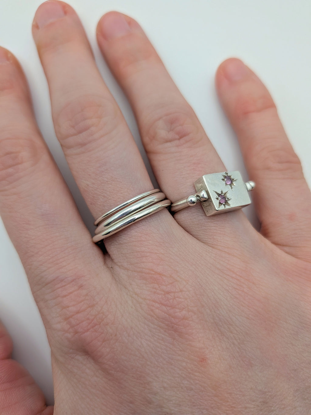 Handmade sterling silver stacking rings in round wire and D-profile designs by All Our Light.