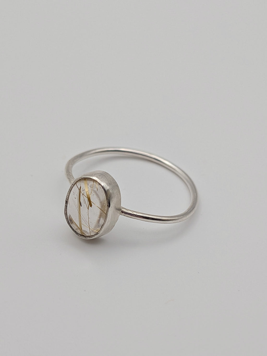 Rutilated quartz gemstone ring in a handmade sterling silver setting by All Our Light.
