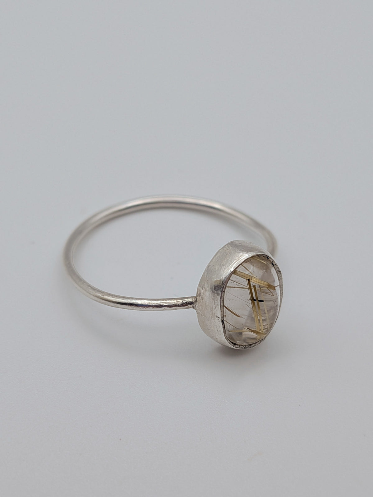 Rutilated quartz gemstone ring in a handmade sterling silver setting by All Our Light.