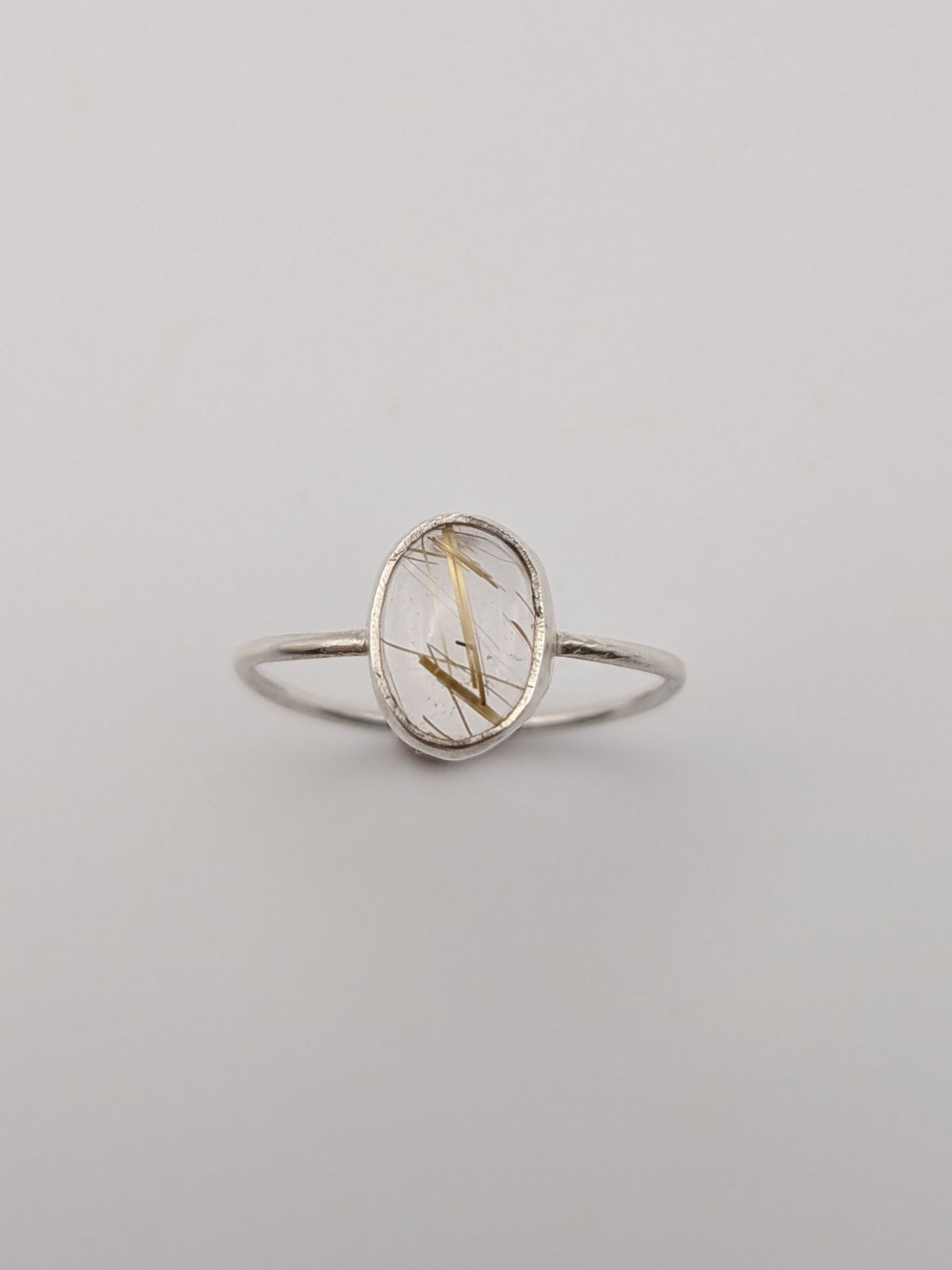 Rutilated quartz gemstone ring in a handmade sterling silver setting by All Our Light.
