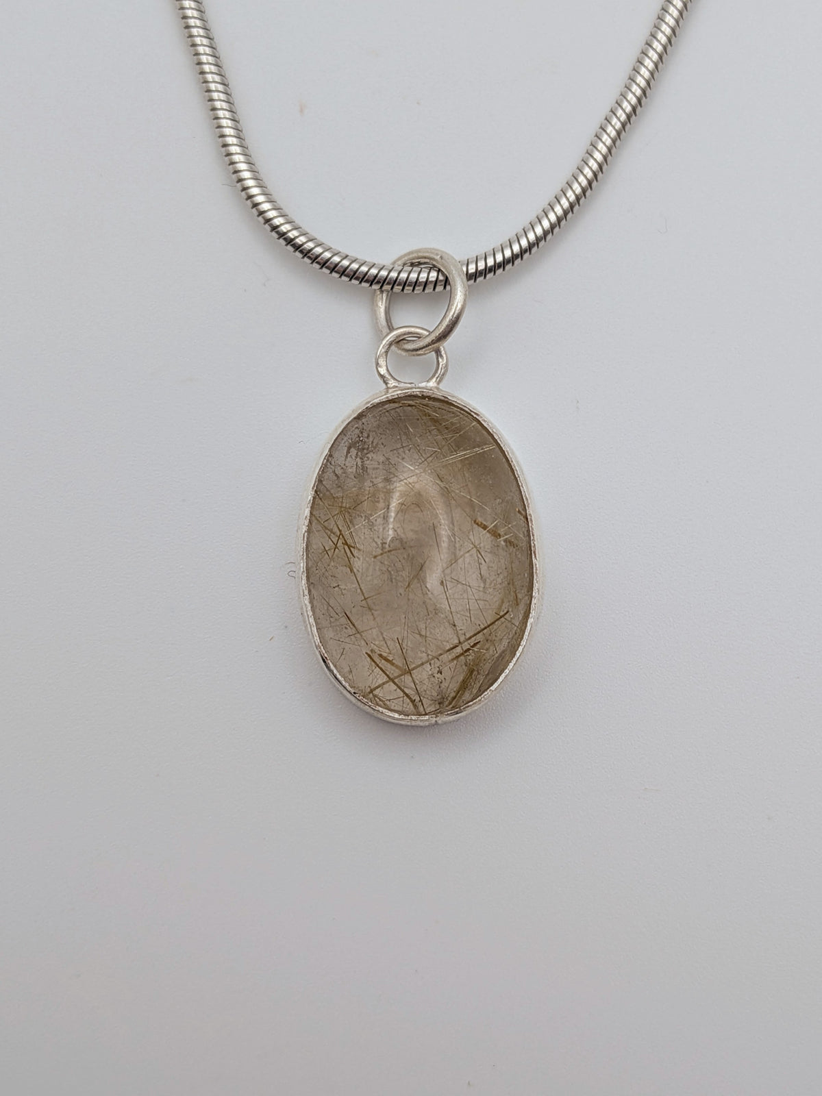 Rutilated quartz pendant in a handmade sterling silver setting by All Our Light.