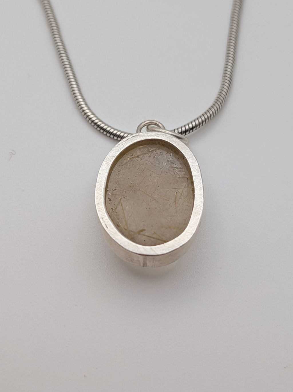 Rutilated quartz pendant in a handmade sterling silver setting by All Our Light.