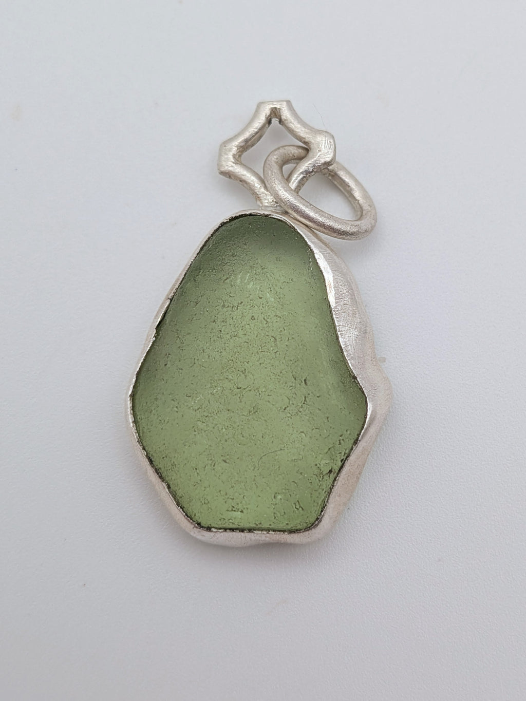 Seafoam green sea glass pendant in a handmade silver setting by All Our Light.